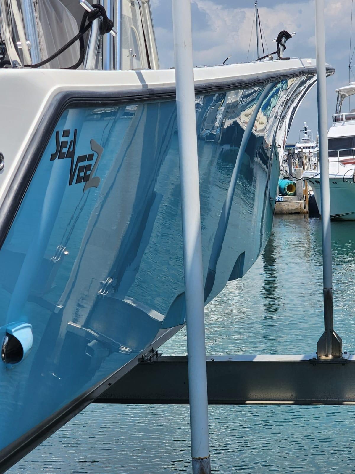 SeaVee hull compounded and polished to a mirror gloss at a Miami dock