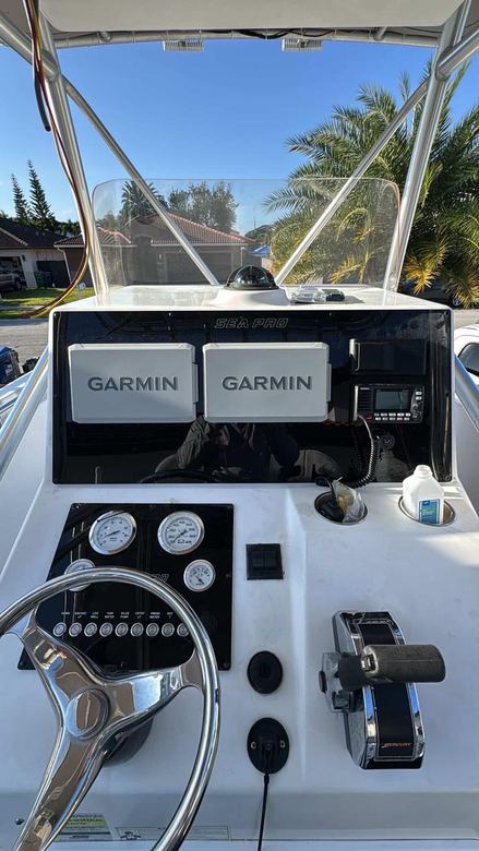 Sea Pro helm with twin Garmin displays, a VHF radio and a refreshed gauge cluster