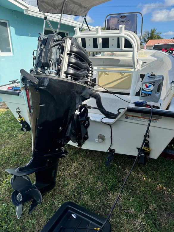 Outboard tilted up for a scheduled oil and filter service on a bay boat